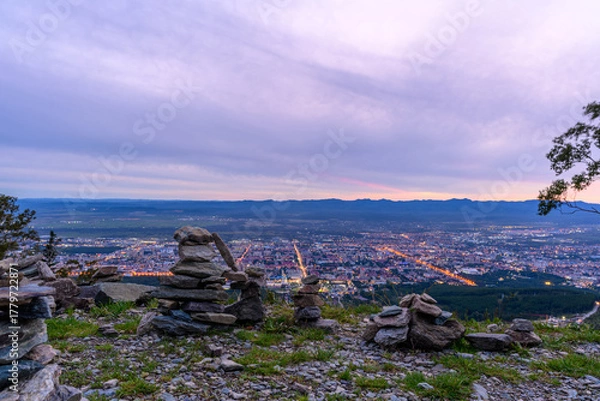 Fototapeta Beautiful evening view of a city from a mountain with natural stone formations