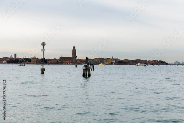 Obraz Murano, Italy - November 21, 2024: Scenic view of Murano Island with historic buildings and serene waters, showcasing the beauty of Venetian architecture and tranquil ambiance