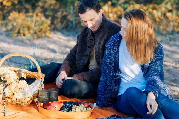 Obraz Portrait happy beautiful couple in love enjoying autumn picnic in autumn park. High quality photo