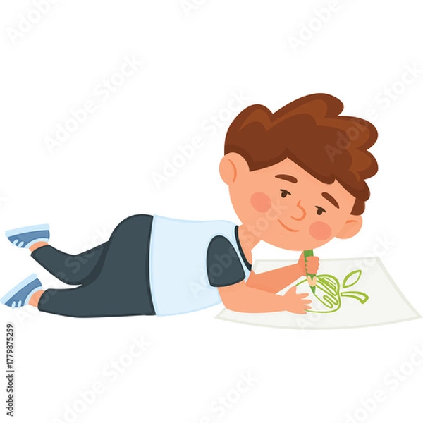 Fototapeta Young boy with brown hair wearing a blue and white shirt and dark pants lying on the floor drawing a green picture on white paper with a green crayon a happy 