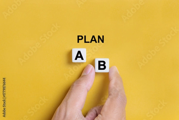 Fototapeta Hand of a businessman choosing business plan b out of two options