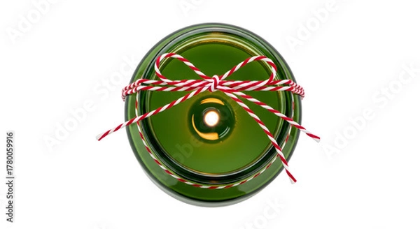 Fototapeta Gift - Green candle with red and white twine tied in a bow, festive decoration for holidays and cozy atmospheres, perfect for Christmas and winter celebrations