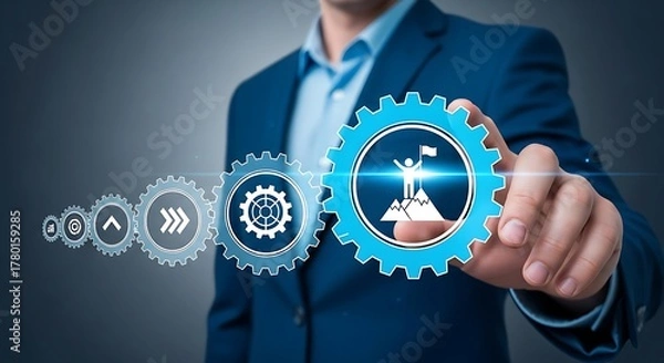 Fototapeta Man in suit touching gear with flag on mountain, symbolizing achievement
