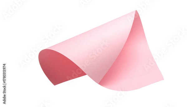 Fototapeta Pink paper sheet curls upward, catching light and shadow against a pure black background