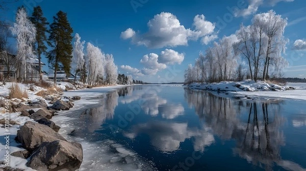 Fototapeta A winter landscape with a frozen lake, showcasing nature's seasonal beauty and tranquil reflection.