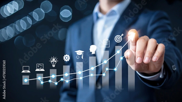 Fototapeta Businessman pointing at a glowing graph with business icons and target symbol