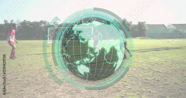 Fototapeta Running eight soccer players in soccer kit across grass field, with globe overlay and soccer ball