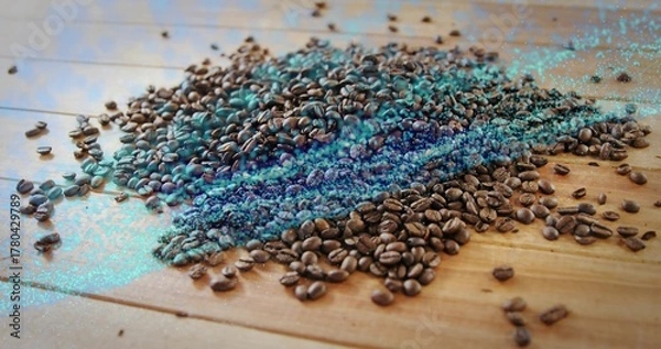 Obraz Displaying roasted coffee beans scattering across wooden tabletop, with turquoise digital artifacts