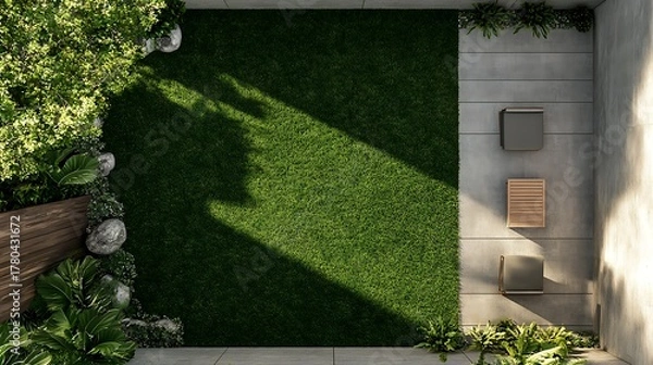 Fototapeta Top-down perspective of a contemporary garden featuring a lush green lawn, concrete patio with minimalist outdoor furniture, and diverse plant life. Ideal for landscape design and home exterior