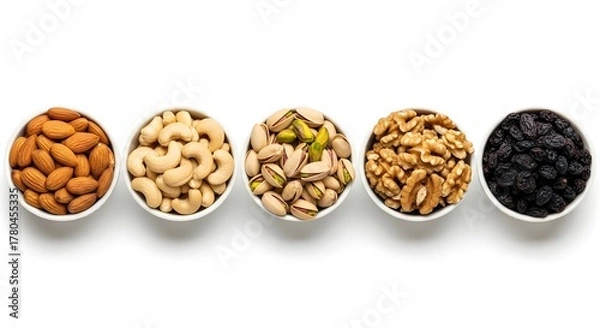 Fototapeta A Healthy Assortment of Dry Fruits Including Almonds, Cashews, Pistachios, Walnuts, and Raisins Arranged Neatly in Bowls, Representing Nutrition and Natural Energy