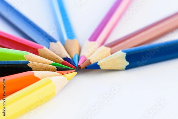 Fototapeta Closeup different colored pencils on white background.