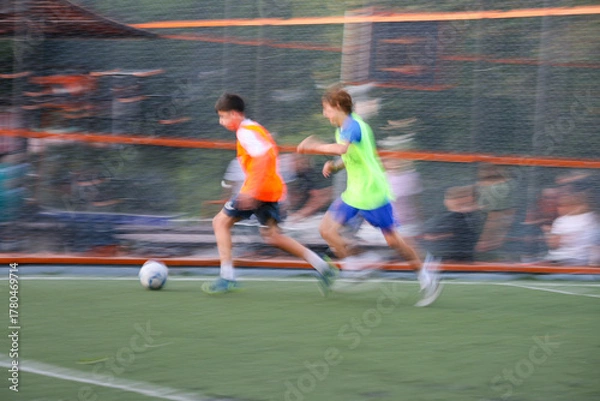 Obraz teens boys plays football at a sports school .Blur