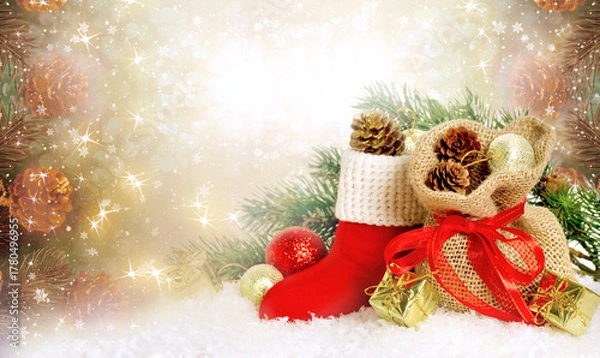Fototapeta Christmas background with decorative Santa red boot and gift bag and box, branch and pine cones for tree decoraton. New Year winter holidays fantasy concept with decor and copy space.