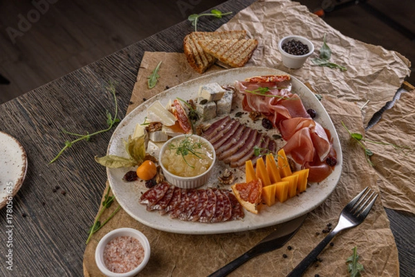 Fototapeta Charcuterie board featuring assorted cheeses