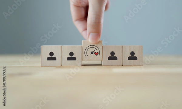 Fototapeta Soft Skills and Leadership concept. Building a team with emotional intelligence. Wooden blocks with emotional intelligence performance icon. Soft skills, leadership and empathy in workplace.