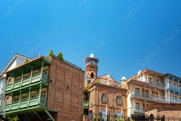 Fototapeta Beautiful historic architecture with balconies and the Juma Mosque visible in the historic center of Tbilisi, Georgia