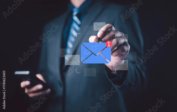 Obraz Businessman touching digital email icon with new message notification, representing online communication, email marketing, digital connection, and modern business technology concept.