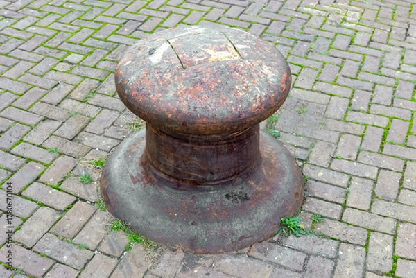 Obraz weathered bollard on the harbor quay