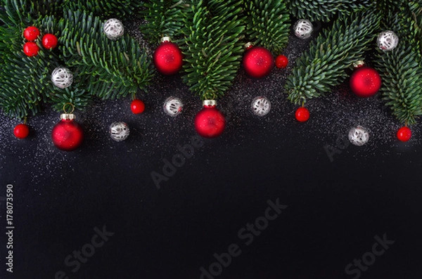 Fototapeta christmas black background with decoration, red berry, bauble and fir tree branch