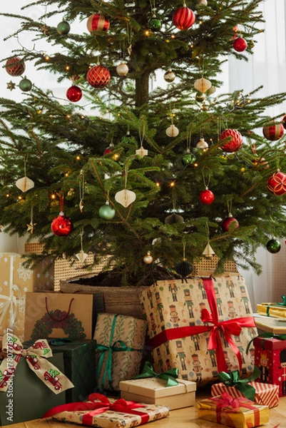 Fototapeta Beautifully decorated Christmas tree with ornaments and wrapped