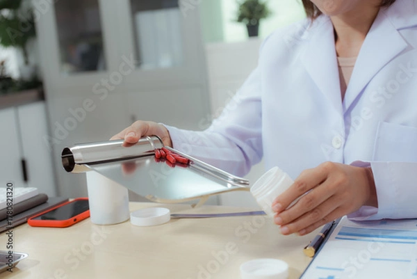 Fototapeta A female doctor examines a patient and explains her diagnosis to him via social media.