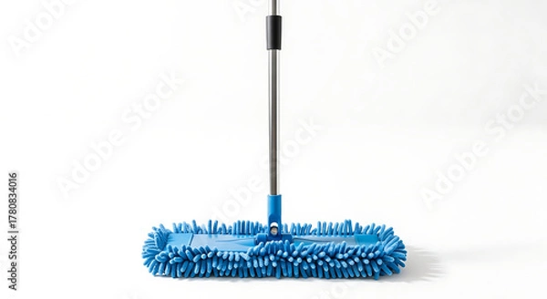 Fototapeta A blue microfiber flat dust mop with a long metal handle for efficient floor cleaning, an essential household tool for daily chores isolated on a white background