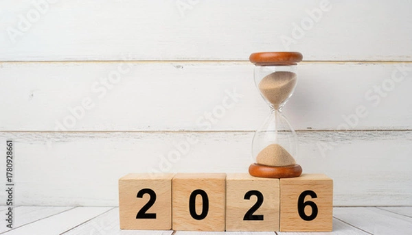 Obraz Hourglass on Top of 2026 Wooden Blocks Representing Time Passing and Planning for the Future