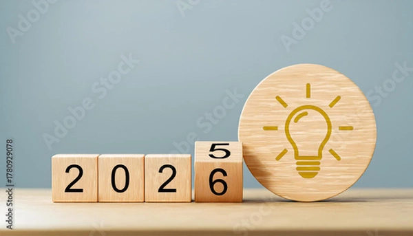 Obraz Yellow Lightbulb Idea Icon with Year Transition from 2025 to 2026 on Wooden Cubes