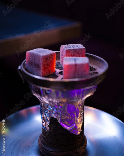Fototapeta Burning coals on hookah bowl — close-up of a water pipe ready to smoke in a modern lounge