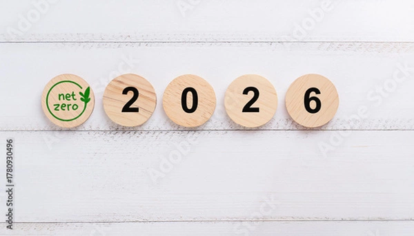 Obraz Green Net Zero Symbol on Wooden Circular Discs Displaying the Year 2026