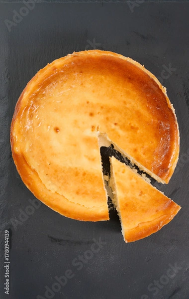 Fototapeta Cheesecake tart with a slice cut serving dessert