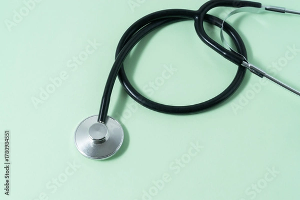 Obraz A stethoscope on light green background