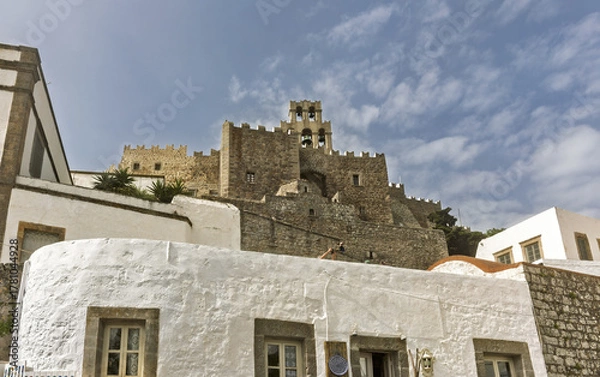 Fototapeta stone bell tower arched openings containing bells, part of a fortified structure with crenellated walls, and whitewashed in the Monastery of Saint John the Theologian of Patmos, Greece.