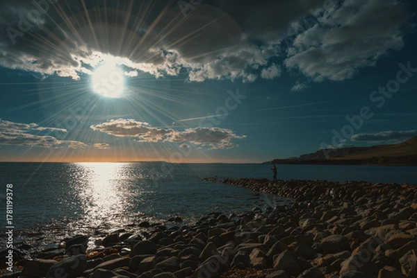 Obraz Dramatic sunset over rocky seashore