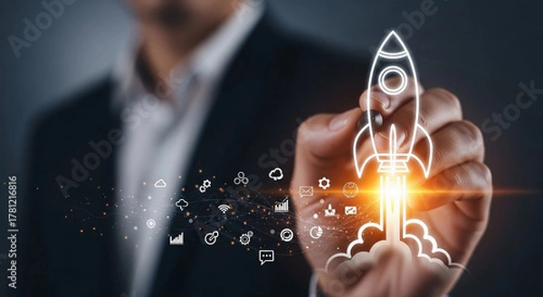 Fototapeta Business man drawing a rocket with digital icons representing startup and innovation concept idea