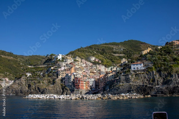 Obraz Panoramic view of the Ligurian coast and the colorful villages of Cinque Terre as seen from the sea on a cruise ship on a clear day. Cinque Terre, Liguria, Italy