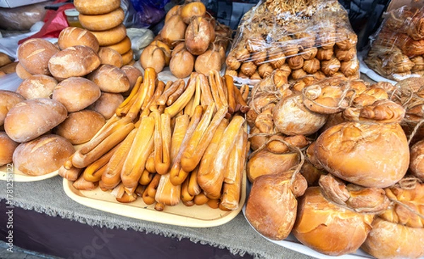 Fototapeta Handmade artisan cheeses are on sale at a farmers market