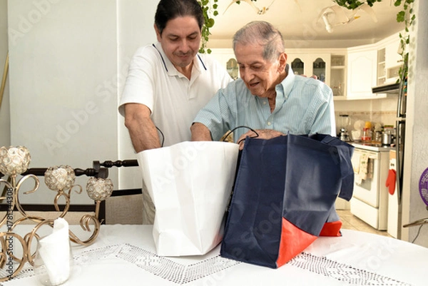 Obraz Father and son of Latin descent enjoying shopping together
