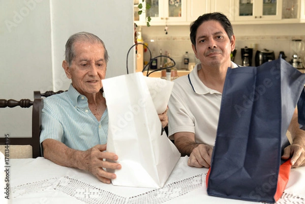 Obraz Father and son of Latin descent enjoying shopping together