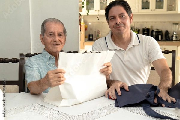 Obraz Father and son of Latin descent enjoying shopping together