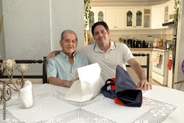 Obraz Father and son of Latin descent enjoying shopping together