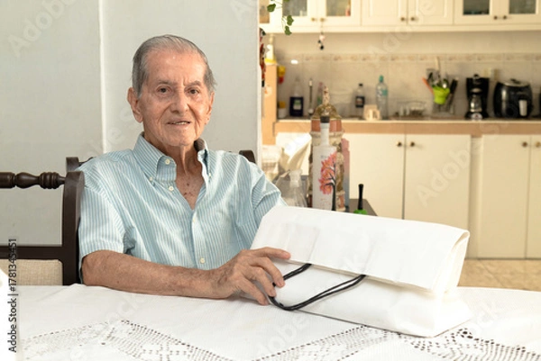 Obraz Latino senior citizen with a white shopping bag