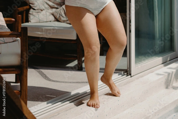 Fototapeta Female adult in swimwear on sunny patio