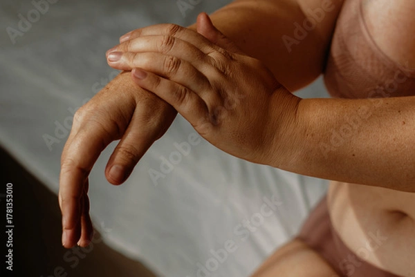 Fototapeta Caucasian female adult relaxing in underwear with focus on hands