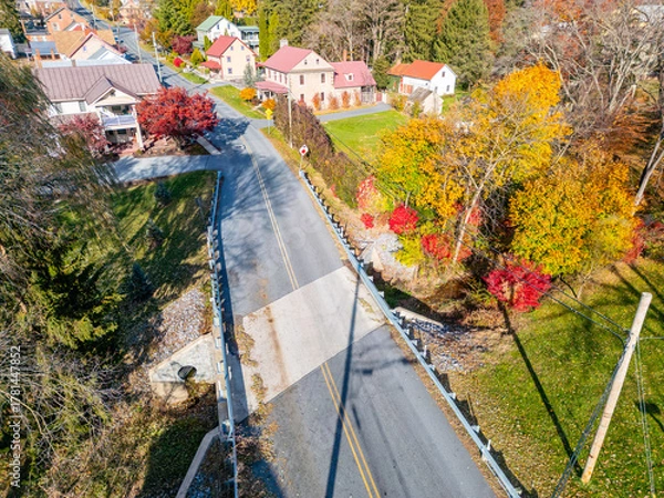 Fototapeta Aerial drone view of a road and bridge during fall. 