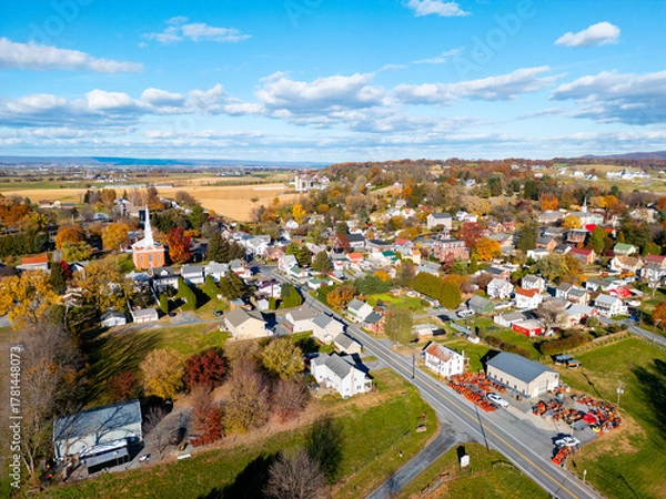 Fototapeta Aerial drone view of a town during fall. 
