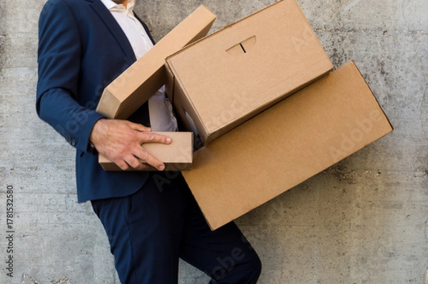 Obraz Businessman dropping some cardboard boxes he was carrying