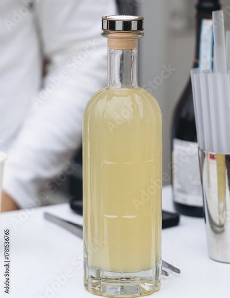 Fototapeta Barman mixing liquor beverages and alcohol drinks in plastic cups, bartender working, beautiful row line of different coloured cocktails on open air summer party in a bar, catering on banquet event