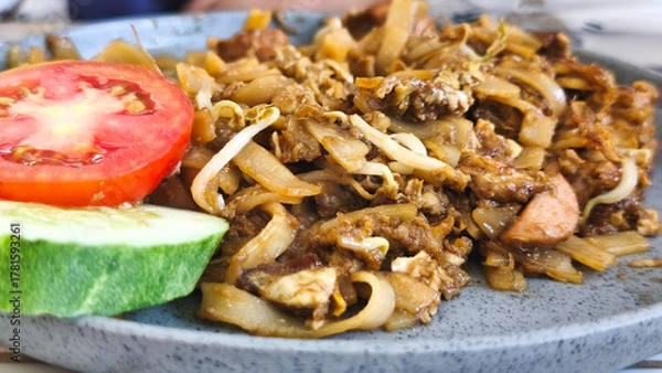 Obraz Kwetiau goreng  is a Chinese Indonesian stir fried flat rice noodle dish made from kwetiau, which are stir fried in cooking oil with garlic, onion ,beef, chicken, fried prawn, crab and other vegetable