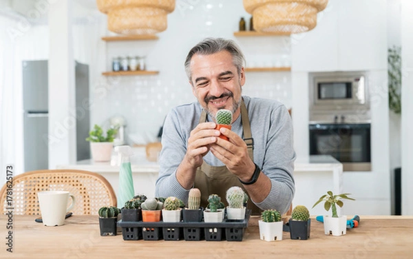 Obraz Portrait of happy sme owner senior caucasian man working gardening cactus succulent. Hobby free time or leisure for mature guy at home, startup small business sme owner, Retirement mature farmer